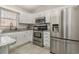 Bright kitchen featuring stainless steel appliances, granite countertops, and white cabinetry at 639 Blackstone Dr., Myrtle Beach, SC 29588