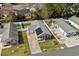 Aerial shot showcasing the home with solar panels, fenced yard, landscaping, and a long driveway at 9840 Conifer Ln., Murrells Inlet, SC 29576