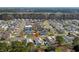 Aerial view of the community showcasing landscaped lawns, manicured trees, and nearby roadways at 9840 Conifer Ln., Murrells Inlet, SC 29576