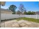 Fenced backyard features a concrete patio and a view of the surrounding trees at 9840 Conifer Ln., Murrells Inlet, SC 29576