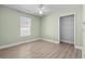 Light-filled bedroom with wood-look floors, ceiling fan, and walk-in closet at 9840 Conifer Ln., Murrells Inlet, SC 29576