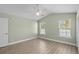 Well-lit bedroom featuring wood-look floors, two windows, and a ceiling fan at 9840 Conifer Ln., Murrells Inlet, SC 29576