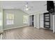 Bedroom with vaulted ceilings, ceiling fan, wood-look floors, and custom closet shelving at 9840 Conifer Ln., Murrells Inlet, SC 29576