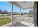 Inviting covered front porch with white railing offering a view of the quiet residential street at 9840 Conifer Ln., Murrells Inlet, SC 29576