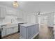 Modern kitchen featuring white cabinets, marble countertops, and a stylish central island at 9840 Conifer Ln., Murrells Inlet, SC 29576