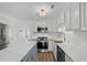 Modern kitchen with stainless steel appliances, white cabinets, and a center island with marble countertops at 9840 Conifer Ln., Murrells Inlet, SC 29576