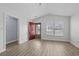 Airy room with light floors, a red door, and a large window providing natural light at 9840 Conifer Ln., Murrells Inlet, SC 29576