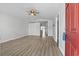 Bright living room with hardwood floors, neutral walls, ceiling fan, and an open doorway leading to other living spaces at 9840 Conifer Ln., Murrells Inlet, SC 29576