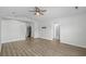 Open-concept living room featuring laminate flooring, a ceiling fan, and seamless transition to the kitchen and dining areas at 9840 Conifer Ln., Murrells Inlet, SC 29576