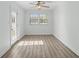 Bright, sunlit room with wood-look flooring, a ceiling fan, and a door to the outside at 9840 Conifer Ln., Murrells Inlet, SC 29576