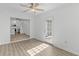 Bright living space with wood-look floors, connecting to the kitchen, and access to the outdoors at 9840 Conifer Ln., Murrells Inlet, SC 29576