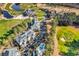 Aerial view showcasing condos, pool, manicured golf course, and a beautiful pond, framed by lush, mature trees at 104 Cypress Point Ct. # 302, Myrtle Beach, SC 29579