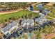 Aerial view of condos, a pool, and a well-manicured golf course with a beautiful pond surrounded by lush trees at 104 Cypress Point Ct. # 302, Myrtle Beach, SC 29579