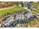 Scenic aerial view of charming condos, a pool, and a well-manicured golf course with a pond amidst lush trees at 104 Cypress Point Ct. # 302, Myrtle Beach, SC 29579