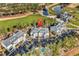 Aerial view of condos, a pool, and a well-manicured golf course with a beautiful pond surrounded by lush trees at 104 Cypress Point Ct. # 302, Myrtle Beach, SC 29579