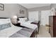 Bright bedroom features two beds, beach decor, neutral walls, and a double closet at 104 Cypress Point Ct. # 302, Myrtle Beach, SC 29579
