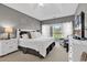 This bright bedroom has a king bed, large windows, and a TV at 104 Cypress Point Ct. # 302, Myrtle Beach, SC 29579