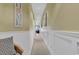Inviting hallway featuring neutral decor, wainscoting, and a glimpse of a cozy living space at 104 Cypress Point Ct. # 302, Myrtle Beach, SC 29579