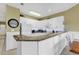 Open kitchen featuring white cabinets and a breakfast bar for additional seating at 104 Cypress Point Ct. # 302, Myrtle Beach, SC 29579