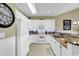 The kitchen features white cabinets, granite counters, and modern stainless steel appliances at 104 Cypress Point Ct. # 302, Myrtle Beach, SC 29579