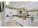 Open kitchen with white cabinetry, granite counters, and an adjoining living area at 104 Cypress Point Ct. # 302, Myrtle Beach, SC 29579