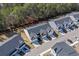 Aerial view of modern townhomes with well-maintained lawns, garages, and ample parking at 115 Galil Dr. # B, Myrtle Beach, SC 29579