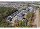Scenic aerial view of a townhome community with pond, surrounded by lush green trees at 115 Galil Dr. # B, Myrtle Beach, SC 29579