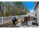 Private backyard with a fenced yard, outdoor grill, and wooden rocking chairs on a sunny day at 115 Galil Dr. # B, Myrtle Beach, SC 29579