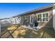 Cozy backyard with a small patio area, featuring an outdoor grill, rocking chairs, and manicured grass at 115 Galil Dr. # B, Myrtle Beach, SC 29579