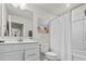 Bright bathroom featuring a tub with shower, white vanity, and a large mirror at 115 Galil Dr. # B, Myrtle Beach, SC 29579