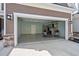 Spacious two-car garage with epoxy flooring, storage cabinets, and two Adirondack chairs at 115 Galil Dr. # B, Myrtle Beach, SC 29579