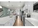 Modern kitchen with white cabinets, stainless steel appliances, and a large island with quartz countertops at 115 Galil Dr. # B, Myrtle Beach, SC 29579
