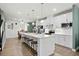 Well-lit, modern kitchen with sleek white cabinets, stainless steel appliances, and a large island with seating at 115 Galil Dr. # B, Myrtle Beach, SC 29579