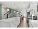 Bright, open kitchen with white cabinetry, quartz countertops, stainless steel appliances, and hardwood flooring at 115 Galil Dr. # B, Myrtle Beach, SC 29579