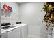 Well-lit laundry room with new washer and dryer, and convenient shelving for storage at 115 Galil Dr. # B, Myrtle Beach, SC 29579