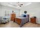A bedroom with tray ceiling, featuring a wooden bed frame, matching nightstands, dresser, and natural light at 115 Galil Dr. # B, Myrtle Beach, SC 29579