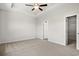 Spacious main bedroom with plush carpet, ceiling fan, walk-in closet and neutral paint at 1200 Cypress Shoal Dr., Conway, SC 29526