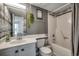 Well-lit bathroom with unique gray wood-look accent wall, toilet, and a shower/tub at 126 N Waccamaw Dr. # 203, Garden City Beach, SC 29576