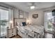 Inviting bedroom with a full bed, side tables with lamps, and two windows providing natural light at 126 N Waccamaw Dr. # 203, Garden City Beach, SC 29576