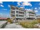 Three-story beach house with multiple decks and ocean views, near sandy dunes at 126 N Waccamaw Dr. # 203, Garden City Beach, SC 29576