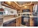 Modern kitchen featuring dark appliances, sleek countertops, and ample cabinet space for storage at 126 N Waccamaw Dr. # 203, Garden City Beach, SC 29576