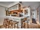 Inviting kitchen bar area with wood-paneled accents and seating, perfect for casual dining and entertaining at 126 N Waccamaw Dr. # 203, Garden City Beach, SC 29576