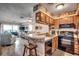 Open kitchen with wood cabinets, stainless steel appliances, and a breakfast bar overlooking the living area at 126 N Waccamaw Dr. # 203, Garden City Beach, SC 29576