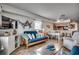 Comfortable living room with a futon sofa, kitchen, and dining table in an open-concept design at 126 N Waccamaw Dr. # 203, Garden City Beach, SC 29576