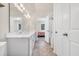 Bright bathroom boasts double vanity, neutral tile flooring, and a shower and tub combo at 138 Marblehead Dr., Little River, SC 29566