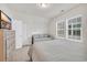 Bedroom featuring a bed with a white comforter near window and dresser at 138 Marblehead Dr., Little River, SC 29566