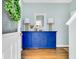 Stylish foyer features a blue accent table, decorative mirror, lamps, and wood flooring at 138 Marblehead Dr., Little River, SC 29566