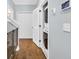 Hallway view with washer/dryer, closet, safety gate, and hardwood flooring at 138 Marblehead Dr., Little River, SC 29566