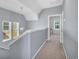 Hallway features gray walls, white trim, and a pendant light, leading to a bedroom at 138 Marblehead Dr., Little River, SC 29566