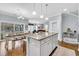 Open-concept kitchen with granite counters, island, pendant lights, and a seamless flow to the living and dining areas at 138 Marblehead Dr., Little River, SC 29566